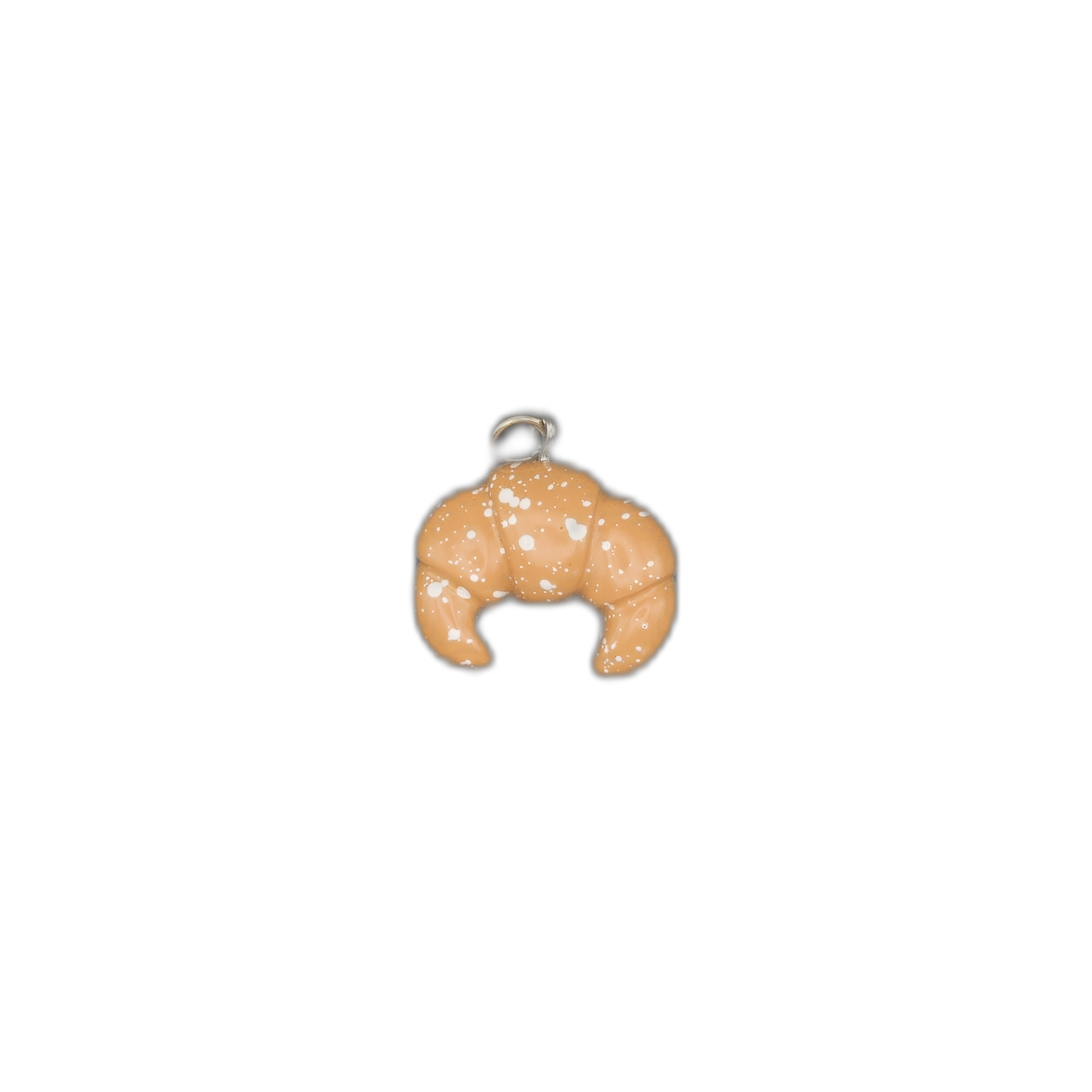 Small croissant enamel charm centered on black background.