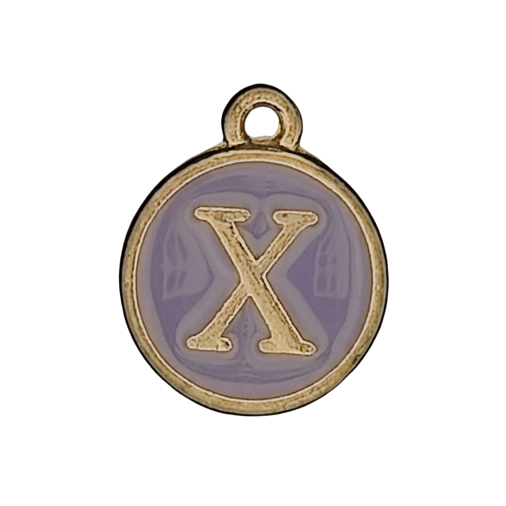 Close-up of a round gold-tone charm with lavender enamel and a raised letter X.