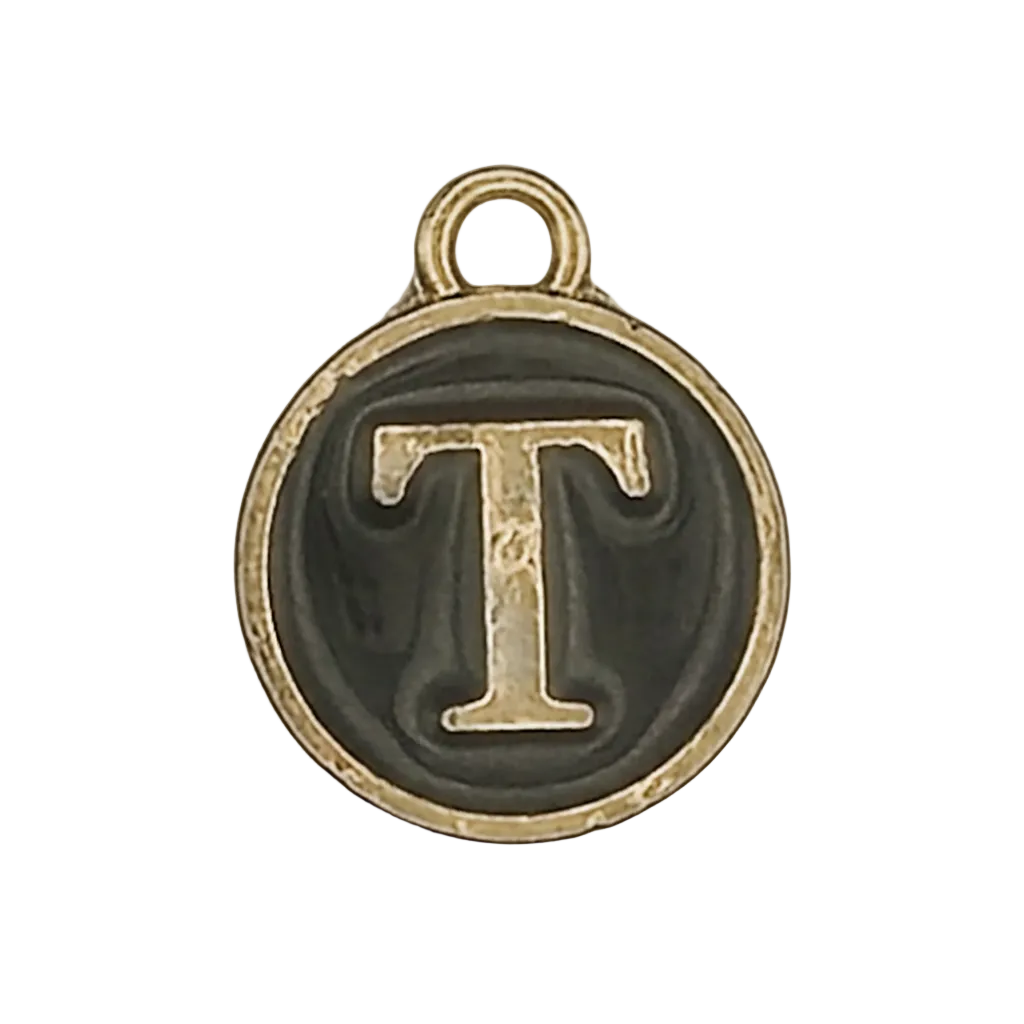 close-up of round gold-tone charm with letter T on black background