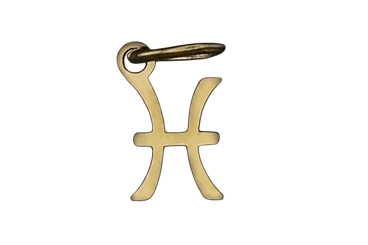 Close-up of a small gold-tone Pisces symbol charm on a black background.