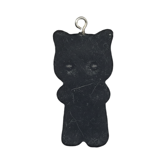 black gummy bear charm with small metal loop on a black background