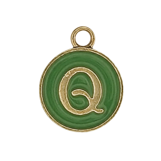 close-up of round green charm with gold letter Q