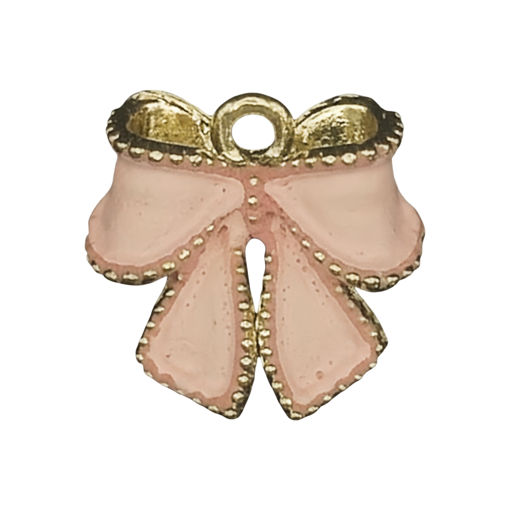 close-up of small pink enamel bow charm with gold trim on black background