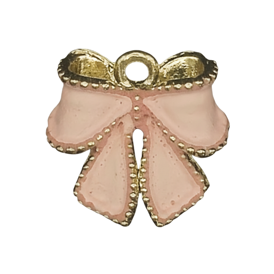 close-up of small pink enamel bow charm with gold trim on black background