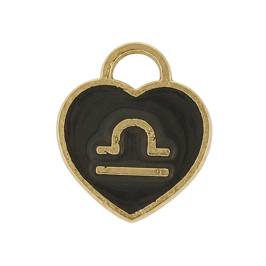 close-up of black and gold heart charm with Libra symbol