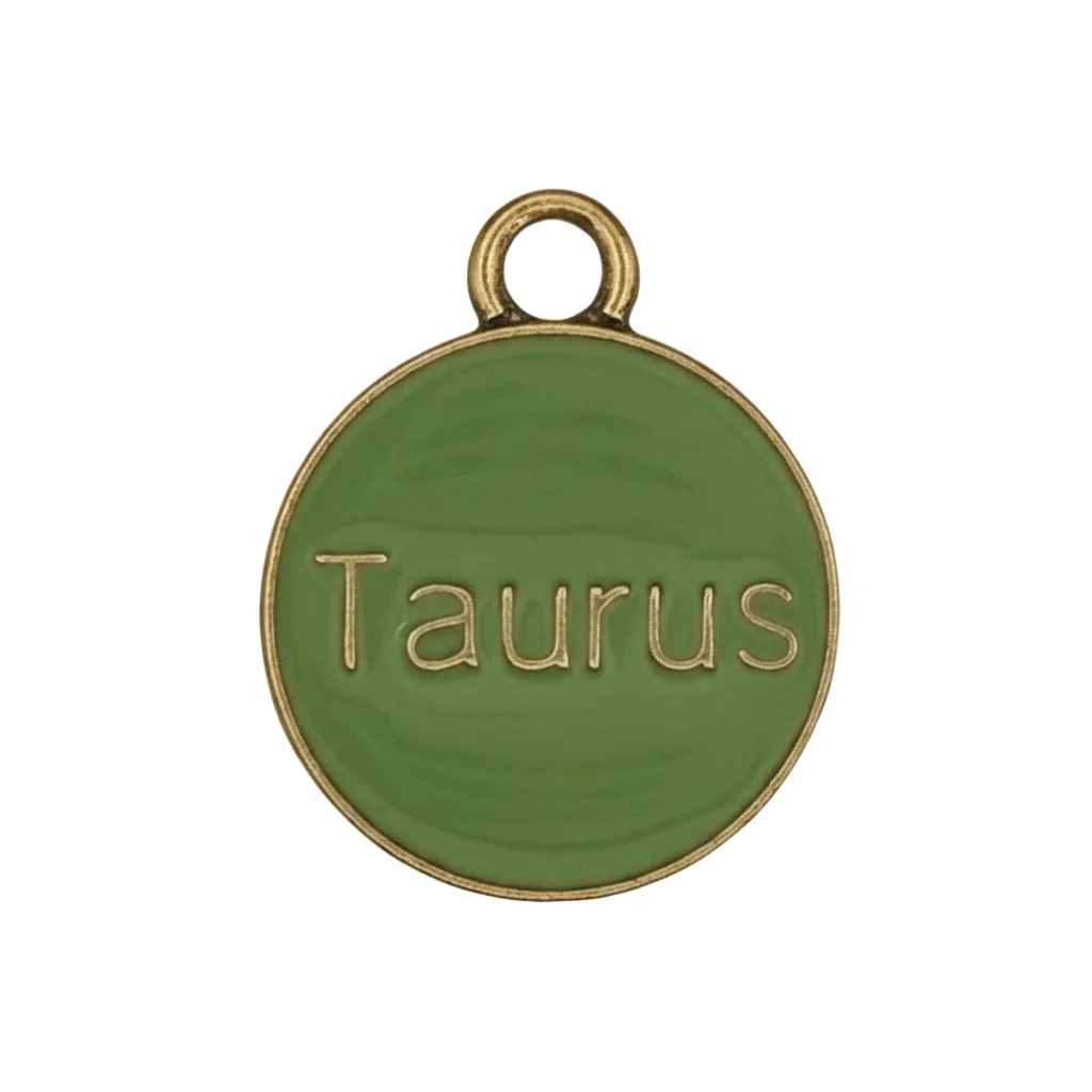 close-up of round green Taurus charm with gold-tone edge on black background