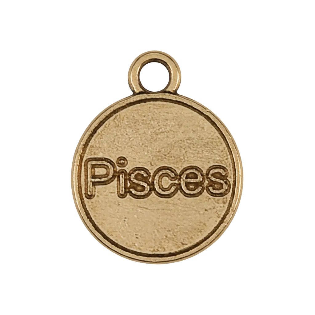 Close-up of a small round gold-tone charm engraved with the word Pisces on a black background.