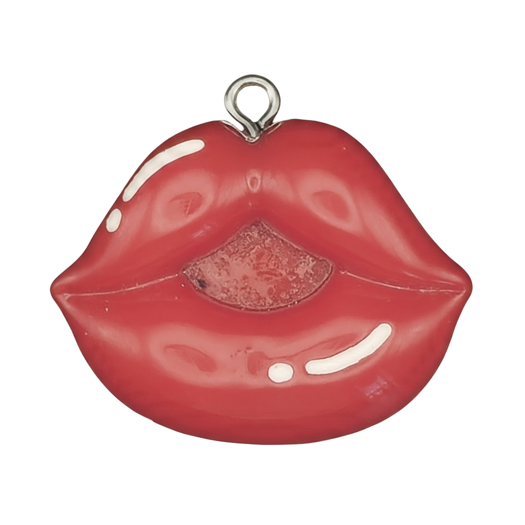 Close-up of a red lips-shaped charm on a black background.