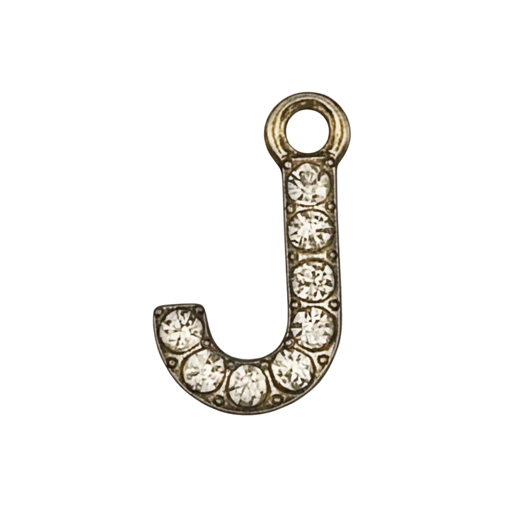 close-up of gold-tone crystal letter J charm on black background