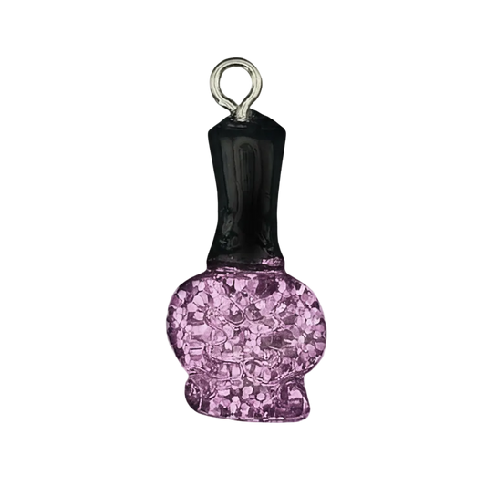 close-up charm shaped like a nail polish bottle with black cap and pink glitter body on black background