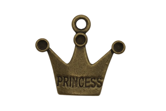 Close-up of an antique brass crown charm engraved 'PRINCESS' on a black background.