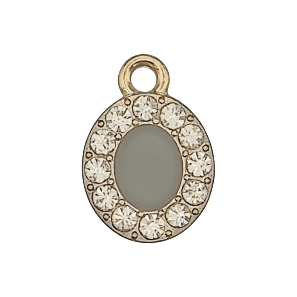 close-up of a small gold-tone letter O charm with clear stones on a black background