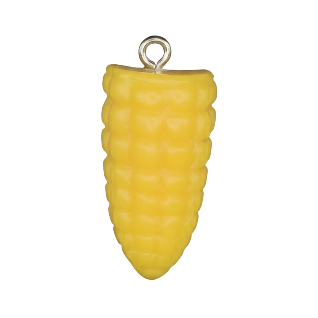 Close-up of a small yellow corn cob charm on a black background.